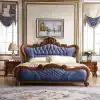 Luxurious blue velvet and wooden bedroom set with ornate carved details, perfect for upscale bedrooms, offering comfort and style with high-quality craftsmanship.