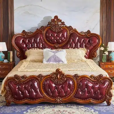 Luxurious carved wooden bedroom furniture with deep red leather upholstery, intricate detailing, and matching bedside tables, creating a regal and classic bedroom ambiance.
