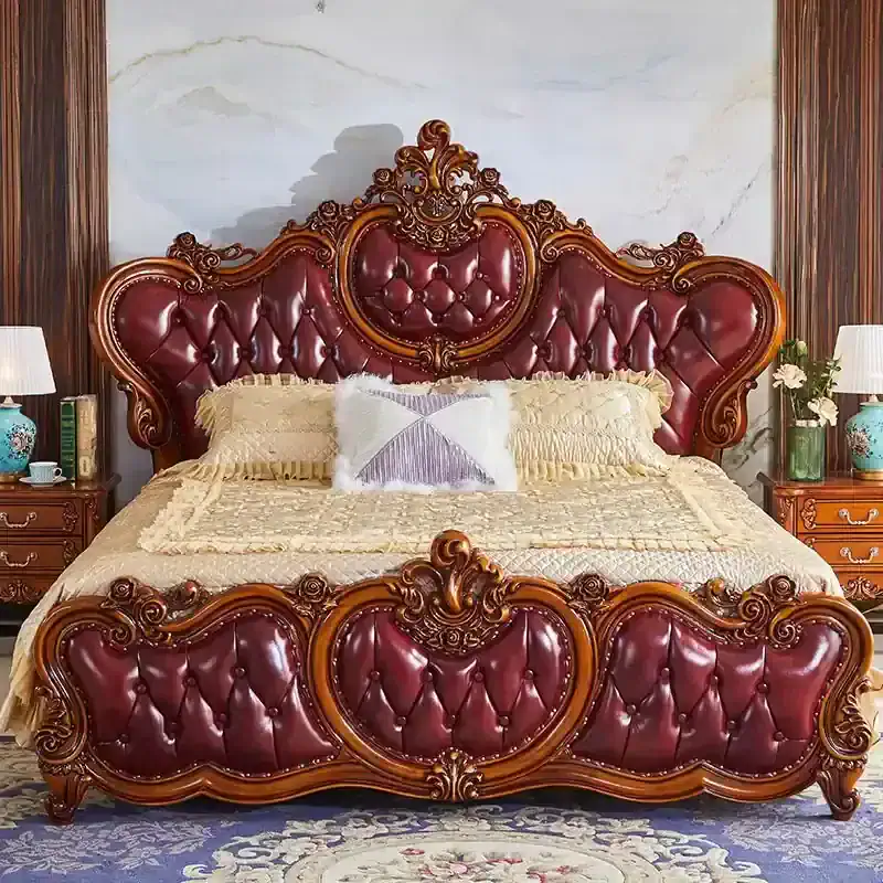 Luxurious vintage bed with carved wooden details and rich red leather upholstery, perfect for a classic bedroom aesthetic. Features an ornate headboard and footboard design.
