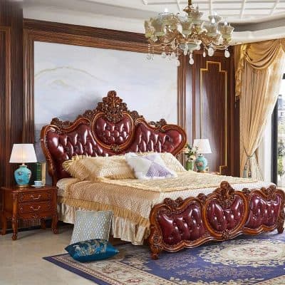 Luxurious bedroom with ornate wooden bed and plush bedding, perfect for upscale homes. Features rich wood accents, classic decor, and vintage-style lamps.