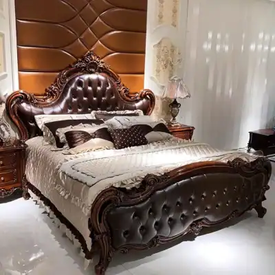 Elegant leather upholstered bed with intricate wood carvings, matching nightstands, and classic decor, showcasing premium bedroom furniture from Monalisa Store.
