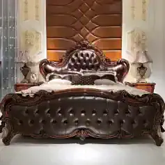 Elegant leather bed with ornate wooden frame and tufted headboard, perfect for luxury bedroom decor and comfort.