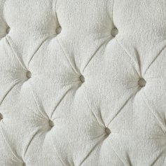 Luxurious white tufted headboard with button accents, ideal for modern bedroom decor, made from soft fabric, providing elegance and comfort.