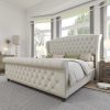 Luxurious white tufted bed with high headboard, in a contemporary bedroom with large windows, cozy decor, ideal for premium bedroom furniture selection.