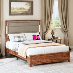 Bright bedroom featuring a stylish wooden bed with a beige upholstered headboard, cozy bedding, and sleek furniture, perfect for a comfortable and luxurious sleep environment.
