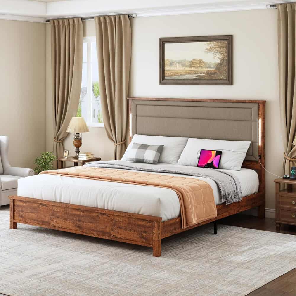 Elegant bedroom featuring a large bed with plush bedding, stylish pillows, and modern electronics. Soft curtains, classic lamps, and artwork create a comfortable, inviting atmosphere for restful sleep.