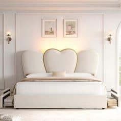 Bright, modern bedroom featuring a stylish heart-shaped headboard, contemporary wall sconces, and clean design, ideal for a comfortable sleep environment.