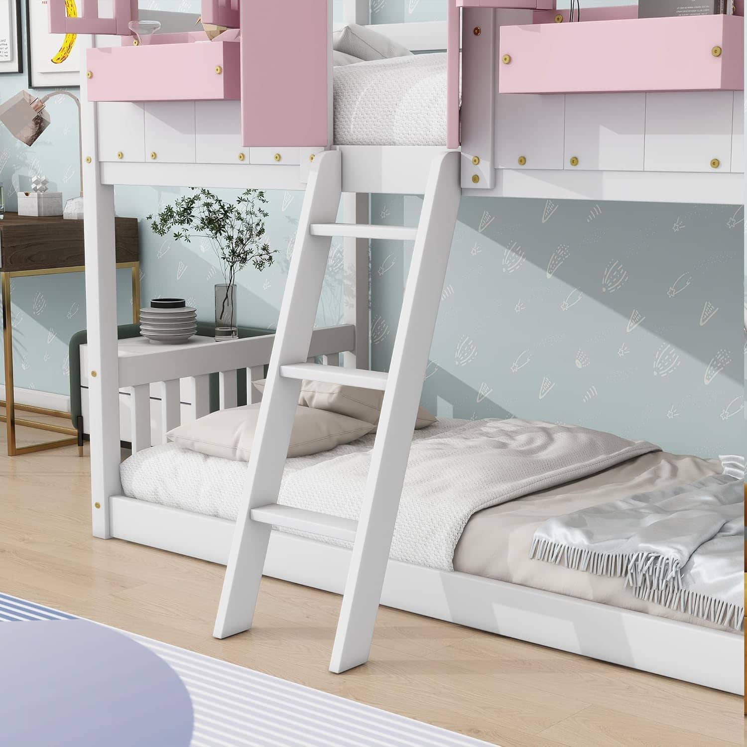 Modern white bunk bed with pink accents, ladder, and safety rails ideal for kids' bedroom, providing safety, comfort, and space-saving design for family bedrooms.
