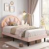 Bright and cozy bedroom with pastel pink bed, whimsical artwork, and soft natural lighting, perfect for a relaxing space for children or teens.
