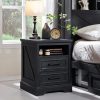 Stylish black bedroom side table with drawers, open shelf for books, modern design, ideal for bedroom decor and organization.