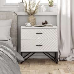 Contemporary white and black bedroom side table with two drawers, stylish handle pulls, and decorative items on top. Perfect for bedroom decoration and bedside storage.