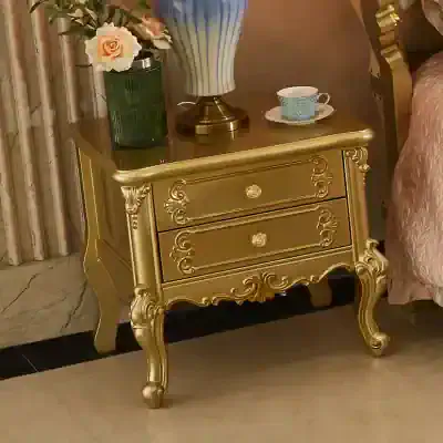 Luxurious gold bedroom side table featuring ornate carvings, vintage design, and spacious drawers, perfect for classic bedroom decor and stylish storage solutions.