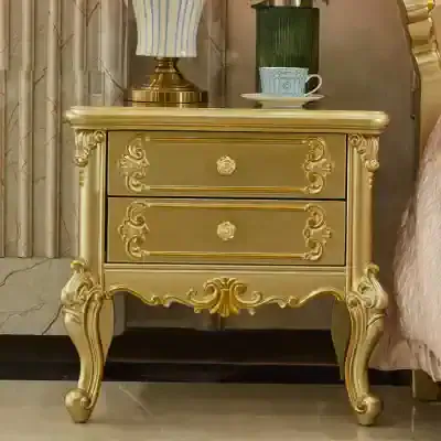 Luxurious gold-colored bedside table with ornate vintage design, perfect for bedroom decor or medical clinic interiors.
