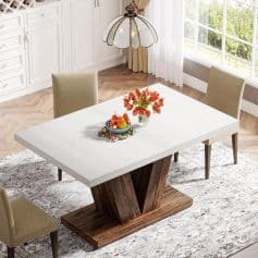 Modern dining table with beige chairs, bright room with large windows, and decorative centerpiece, ideal for home dining, family gatherings, and stylish interior design.