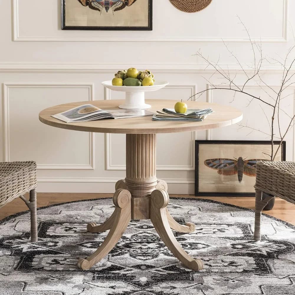 Classic round wooden dining table with sturdy pedestal base, ideal for contemporary and traditional dining spaces. Perfect for family dinners and gatherings.