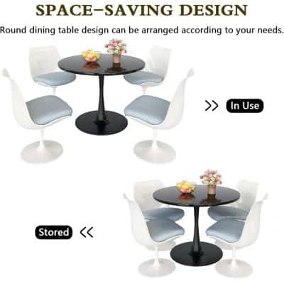 A contemporary round dining table set with white chairs and a black tabletop, ideal for modern interiors, cafes, and office break rooms, offering space-saving and stylish seating solutions.