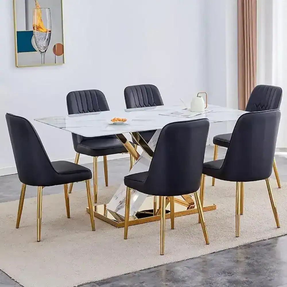 Elegant dining room set featuring black upholstered chairs with tufted backs, a white marble table with gold geometric legs, perfect for contemporary interiors.