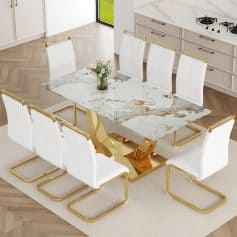Elegant modern marble dining table with gold accents, perfect for high-end interiors, featuring sleek white chairs and a stylish kitchen background.