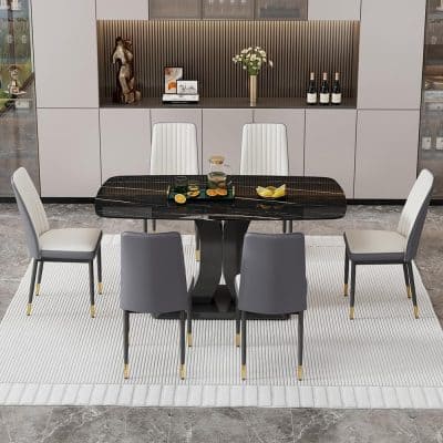 Luxurious dining area with a black marble table, white and gray upholstered chairs, and tasteful decor, showcasing a chic and modern ambiance ideal for upscale homes and interior design inspiration.