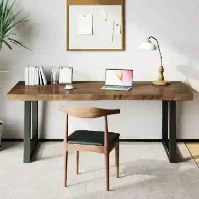 Office desk with laptop, study lamp, notebooks, and decorative elements in a clean, modern workspace. Ideal for work from home or professional office settings.