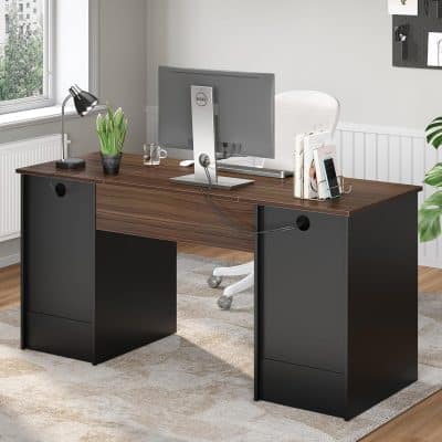 A stylish office desk with a sleek wood finish, ergonomic chair, monitor, desk lamp, and decorative plants, perfect for professional workspace setups.