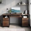 A stylish office desk featuring sleek wood finish, organized workspace with monitor, books, plants, and stylish decor. Perfect for a contemporary home or professional workspace.