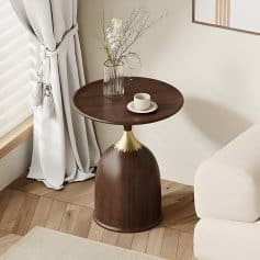 Timeless wooden side table with gold details, perfect for a cozy, stylish living room decor. Features a white coffee cup and a decorative vase with branches and white flowers, nearby white curtains and neutral-colored furniture.