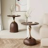 Stylish side tables featuring minimalist design, glass vases with flowers, and cozy living room elements, perfect for enhancing contemporary interior aesthetics.