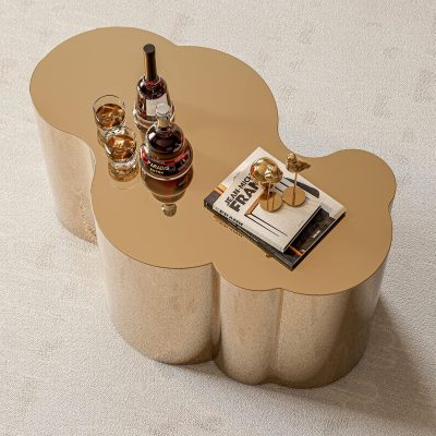 Elegant gold coffee table with liquor bottles, books, and decorative items, perfect for an upscale optical store ambiance.