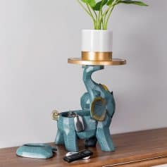 A creative elephant-shaped lamp holding a potted plant, blending unique design with functionality to enhance your interior space.