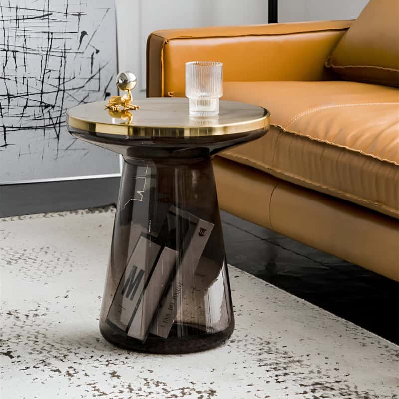 Contemporary glass side table with a sleek black base, showcasing stylish decor accessories, perfect for modern living rooms.