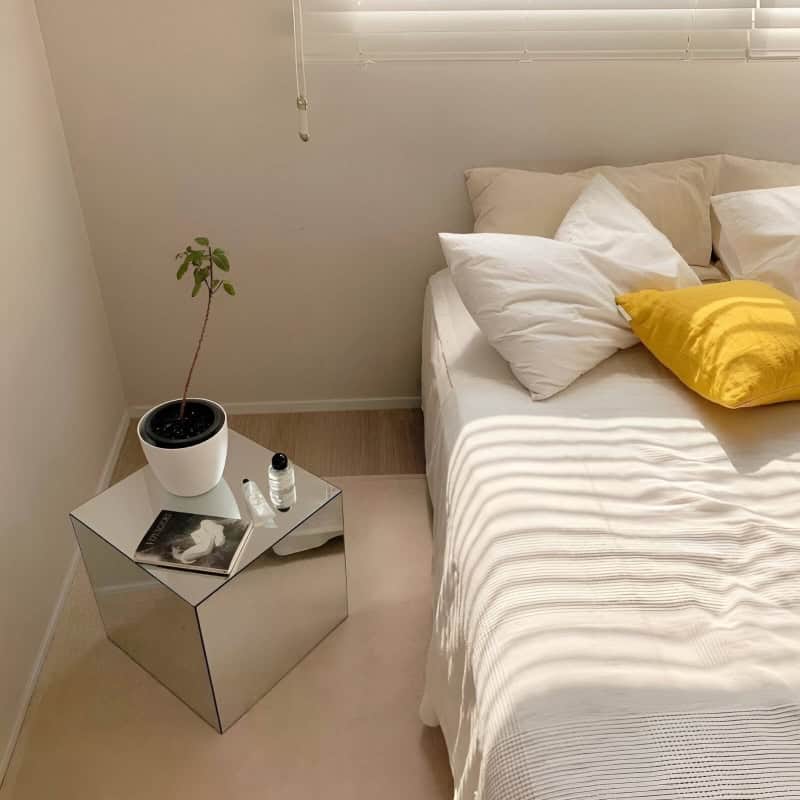 Modern bedroom with cozy bed and natural sunlight, showcasing a peaceful environment for optical and eye health services. Ideal for relaxing visits to Monalisa Store optometry center.