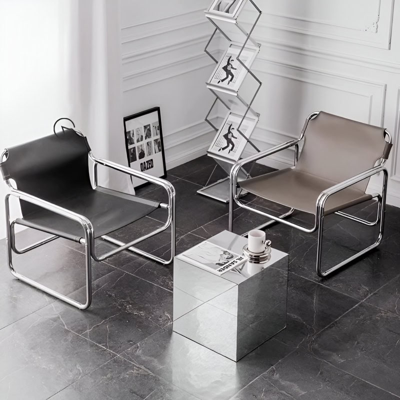 Contemporary seating in a minimalist optical store with chrome-framed chairs, a mirrored side table, artwork, and magazine rack for a fashionable eyewear shopping experience.