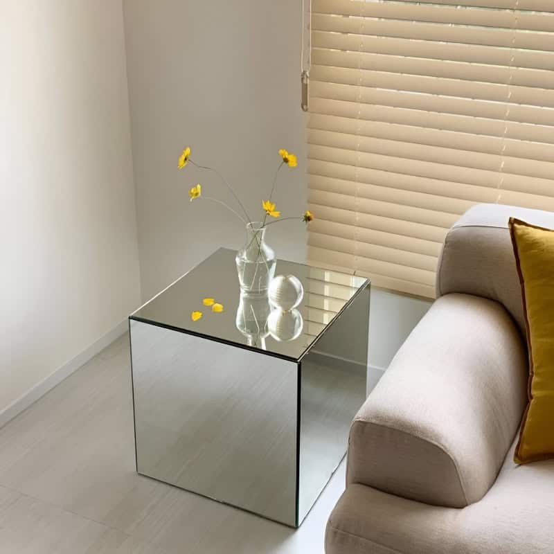 Stylish modern living room with chic glass side table and decorative vase, perfect for eyewear boutique or optometry retail space.