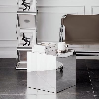 Elegant optical store interior with stylish furniture, art books, and curated decor emphasizing eyeglasses and vision care, creating a sophisticated shopping environment.