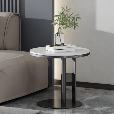 Sleek side table in a contemporary living room with a white marble top and black metal base, decorated with a glass vase containing greenery and books, perfect for stylish home decor.