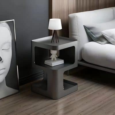 Elegant bedroom decor featuring a contemporary nightstand, artistic portrait, and cozy bedding for a comfortable and modern retreat.