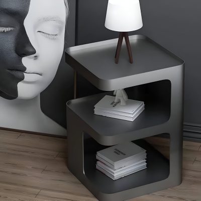 Elegant gray modern side table with books and a stylish lamp for optical store interior decoration.