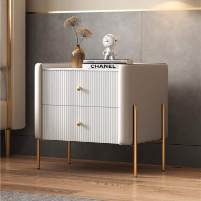 Stylish white sideboard with gold accents, perfect for home decor and storage, featuring decorative items like vase and books for an upscale aesthetic.