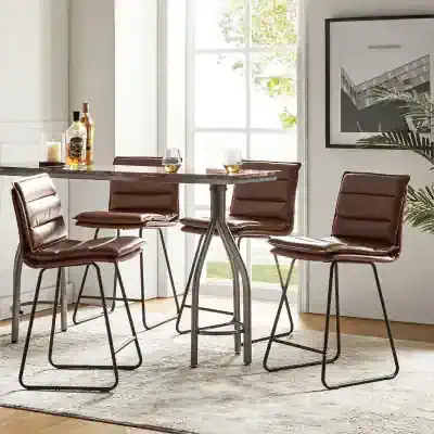 Elegant leather dining chairs with metal legs around a modern table, ideal for stylish kitchens or cafes, featuring natural light and contemporary decor.