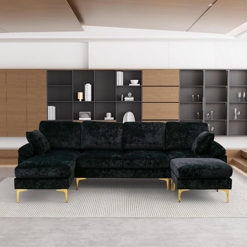 Stylish black velvet sofa with gold legs in contemporary living room setting, perfect for modern interior decor and comfort.