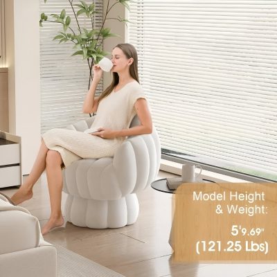 Relaxing woman sitting on a plush white armchair, enjoying a drink in modern spa or salon setting, ideal for beauty, wellness, or medical therapy environments.