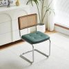 Stylish office chair with rattan backrest, plush teal cushion, and chrome frame, ideal for professional or home workspaces. Enhances comfort and aesthetic appeal in any office setting.
