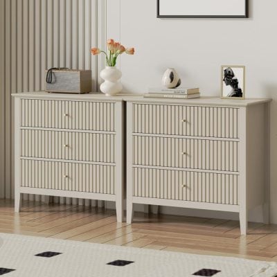 Stylish white dresser with slatted drawers and gold knobs, perfect for bedroom or living room storage and aesthetic enhancement.