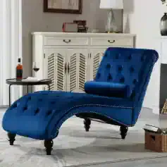 Luxurious royal blue tufted lounge chair with matching bolster pillow, perfect for modern living rooms and relaxing spaces.