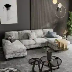 Elegant grey sectional sofa with decorative pillows in contemporary living room setting.