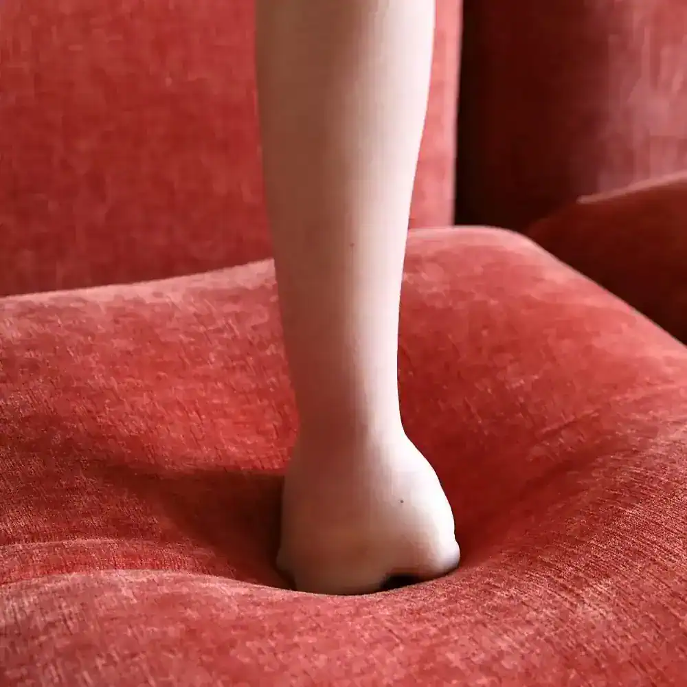 Close-up of a vintage red velvet armchair with wooden armrest within Monalisa Store. Perfect for luxury home decor, furniture shopping, and interior design needs.