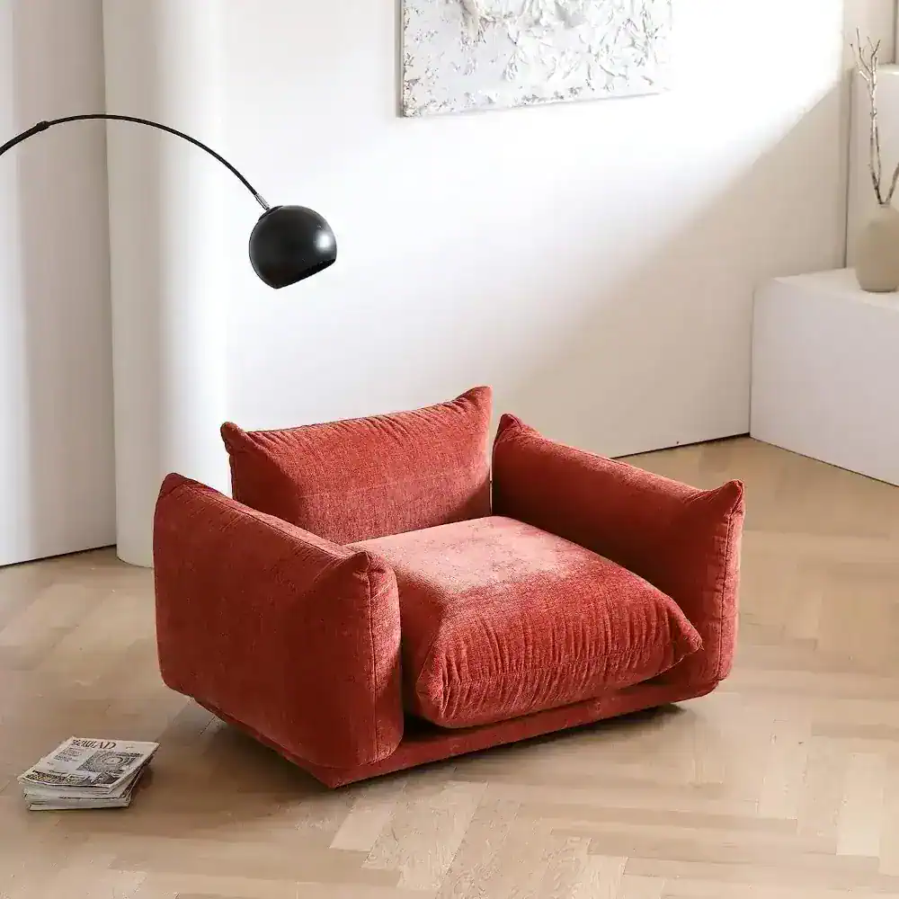 Modern red upholstered armchair ideal for reading and relaxing in stylish living rooms or offices. Durable fabric, comfortable design, perfect for adding vibrant style to your space.