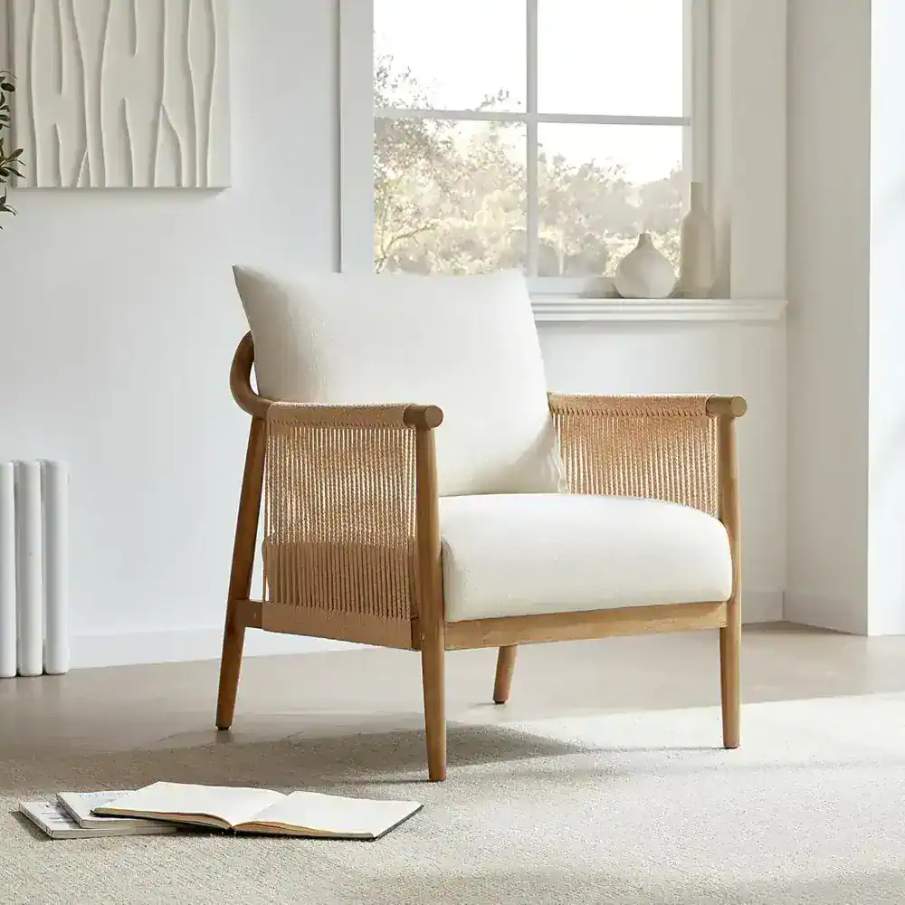 Bright and stylish wooden armchair with a plush white cushion, perfect for modern or minimalist living spaces, offering comfort and aesthetic appeal.