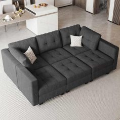 Comfortable black sofa with throw pillows in an optometry clinic lobby setting for patient relaxation.